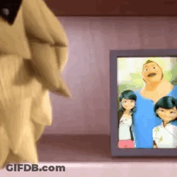 A Cartoon Character Is Standing Next To A Picture Of A Family On A Table . GIF