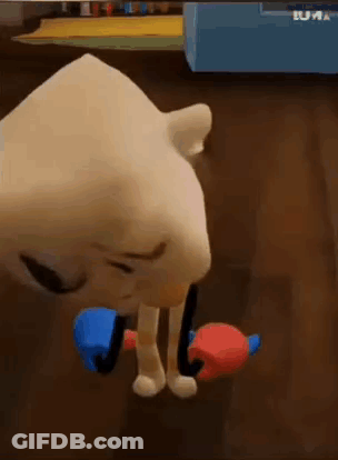 A Cartoon Character Is Standing On A Wooden Floor Holding A Red And Blue Object . GIF