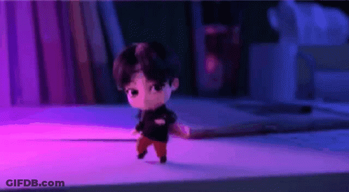 A Cartoon Character Is Walking On A Table In A Room . GIF
