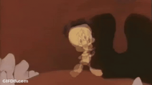 A Cartoon Character Is Walking Through A Cave While Holding A Sword . GIF