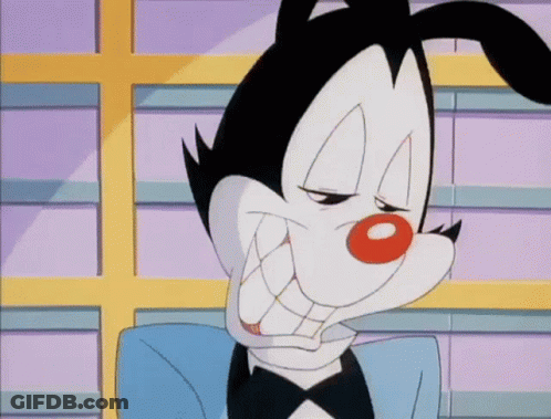 A Cartoon Character Is Wearing A Tuxedo And Making A Face . GIF
