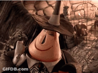 A Cartoon Character Is Wearing A Witch Hat And Holding A Spider . GIF
