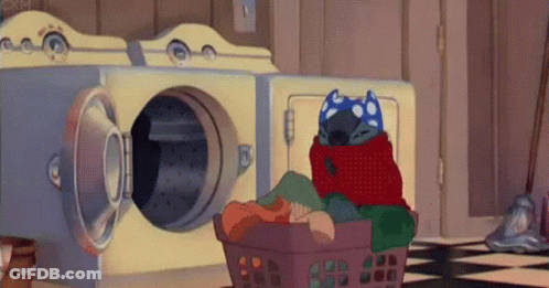 A Cartoon Character Is Wrapped In A Blanket And Sitting In A Laundry Basket . GIF