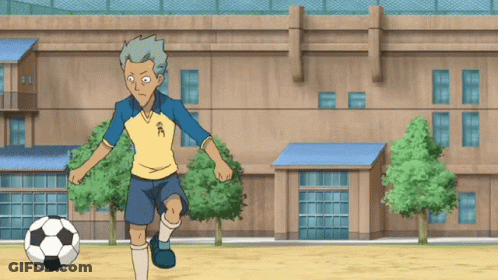 A Cartoon Character Kicks A Soccer Ball In Front Of A Building With Chinese Characters On It GIF