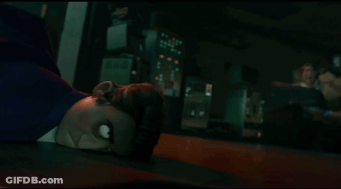 A Cartoon Character Laying On The Floor With A Crowd Behind Him GIF