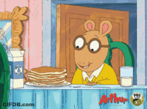 A Cartoon Character Named Arthur Sits At A Counter With Pancakes And Milk GIF
