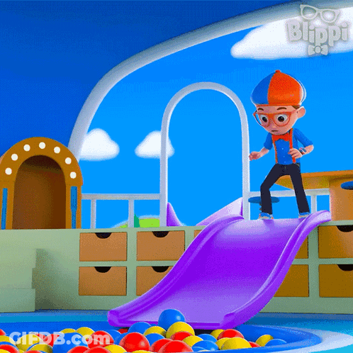 A Cartoon Character Named Blippi Is Playing On A Slide In A Pool Of Balls GIF