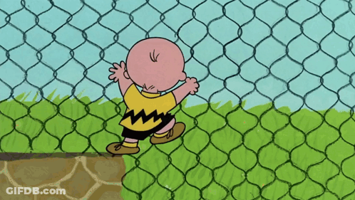 A Cartoon Character Named Charlie Brown Stands Behind A Chain Link Fence GIF
