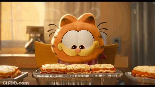 A Cartoon Character Named Garfield Is Sitting At A Table Eating Sandwiches GIF
