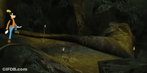 A Cartoon Character Named Goofy Walks Through A Dark Cave GIF
