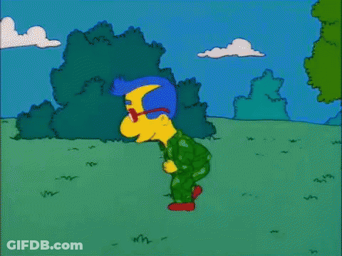 A Cartoon Character Named Milhouse Simpson Is Walking Through A Grassy Field GIF