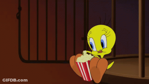 A Cartoon Character Named Tweety Is Holding A Popcorn Bucket GIF