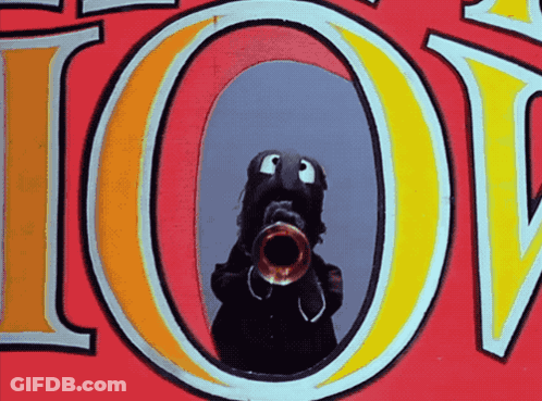 A Cartoon Character Playing A Trumpet In Front Of The Word Joy GIF