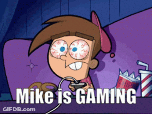 A Cartoon Character Playing A Video Game With The Words Mike Is Gaming Below Him GIF