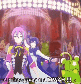 A Cartoon Character Says Kae Gives U A Mwah In Front Of A Merry Go Round . GIF