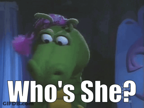 A Cartoon Character Says Who 'S She In Front Of A Curtain GIF