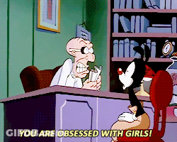 A Cartoon Character Says " You Are Obsessed With Girls " While Sitting At A Desk GIF