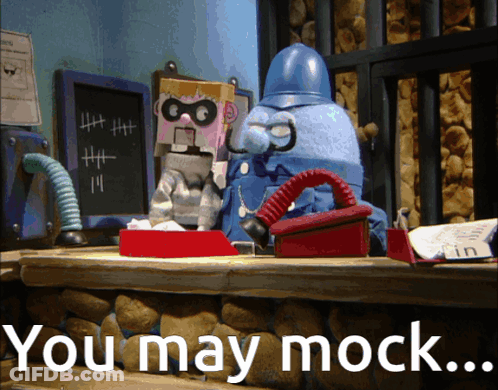 A Cartoon Character Sitting At A Desk With The Words You May Mock GIF
