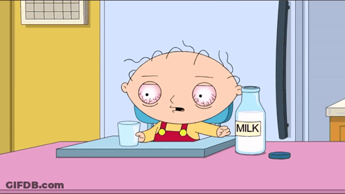 A Cartoon Character Sitting At A Table With A Bottle Of Milk Next To Him GIF