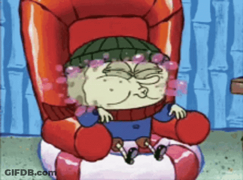 A Cartoon Character Sitting In A Chair With Bubbles Coming Out Of His Eyes GIF