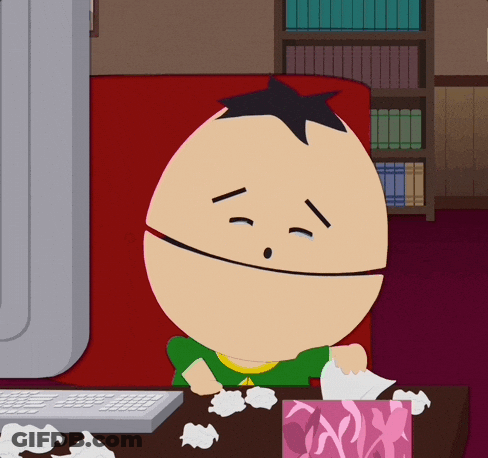 A Cartoon Character Sitting In Front Of A Computer With A Box Of Tissues GIF