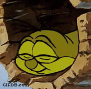A Cartoon Character Sleeping In A Hole In A Rock GIF