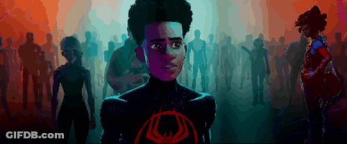 A Cartoon Character Stands In Front Of A Crowd With A Red Eye On His Chest GIF