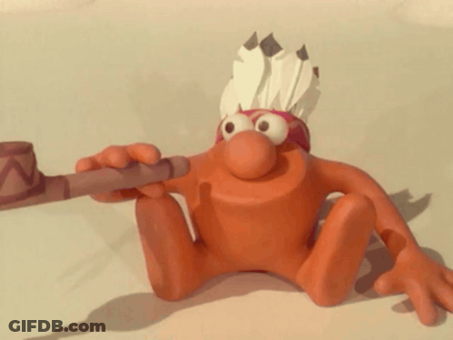 A Cartoon Character Wearing A Feathered Headdress And Holding A Pipe GIF
