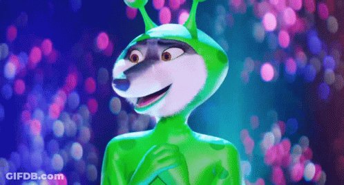 A Cartoon Character Wearing A Green Alien Costume Is Standing In Front Of A Blurry Background . GIF