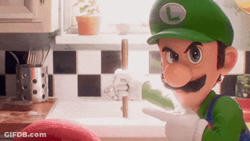 A Cartoon Character Wearing A Green Hat With A L On It GIF