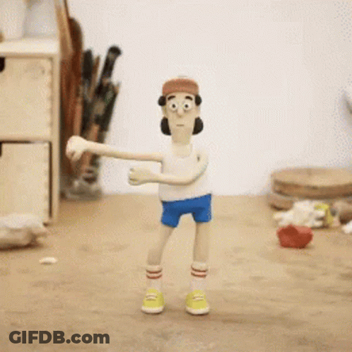 A Cartoon Character Wearing A Hat And Shorts Is Standing On A Wooden Table GIF