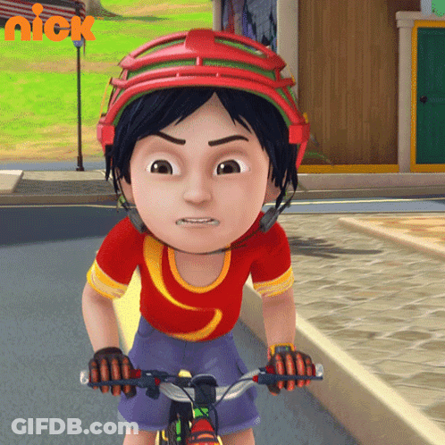 A Cartoon Character Wearing A Helmet Is Riding A Bike With A Nick Logo In The Background GIF