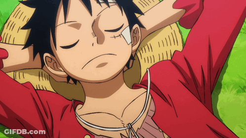 A Cartoon Character With A Bandage On His Face Is Laying On The Grass With His Eyes Closed GIF