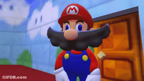 A Cartoon Character With A Beard And A Red Hat With A M On It GIF
