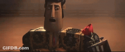 A Cartoon Character With A Box On His Head Holding A Red Rose . GIF