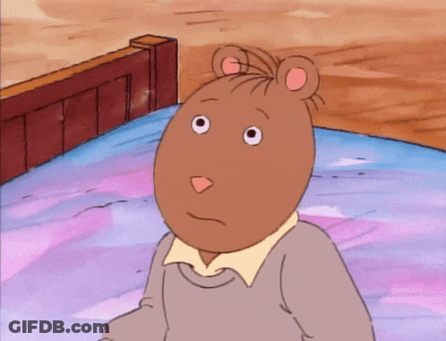 A Cartoon Character With A Mouse Head Is Sitting On A Bed With His Hand To His Chin GIF
