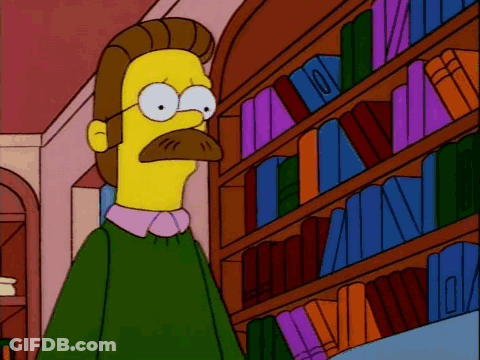 A Cartoon Character With A Mustache Stands In Front Of A Bookshelf Full Of Books GIF