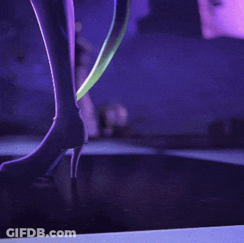 A Cartoon Character With A Purple Background And A Blue Triangle On Her Chest GIF