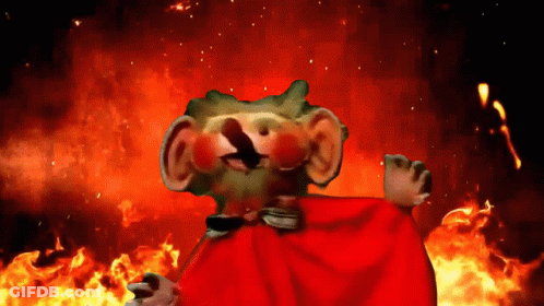 A Cartoon Character With A Red Cape Stands In Front Of A Fire GIF