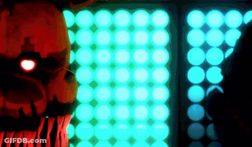 A Cartoon Character With A Red Eye Stands In Front Of A Wall Of Blue Lights GIF