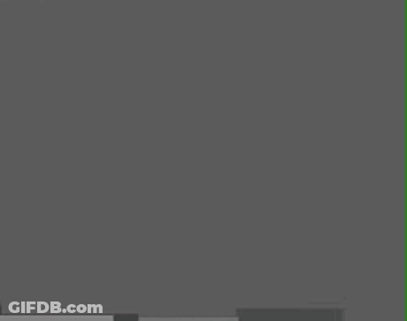 A Cartoon Character With A Triangle On His Head Is Standing In Front Of A Gray Wall . GIF
