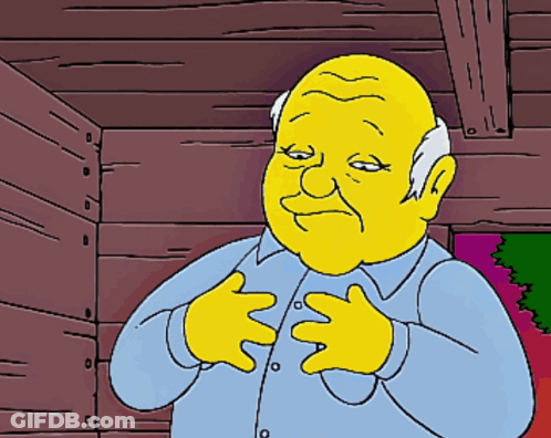 A Cartoon Character With A Yellow Face And A Blue Shirt Has His Hands On His Chest GIF