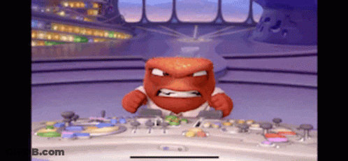 A Cartoon Character With An Angry Face Is Sitting At A Desk GIF