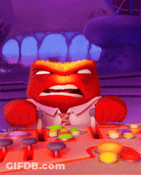 A Cartoon Character With An Angry Face Is Sitting At A Desk With Buttons GIF