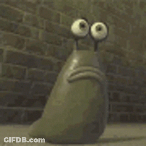 A Cartoon Character With Big Eyes Is Sitting In Front Of A Brick Wall With Its Mouth Open . GIF
