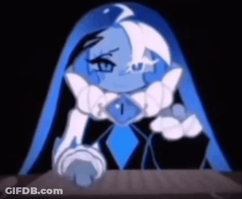 A Cartoon Character With Blue Hair And A Blue Necklace Is Sitting At A Table In A Dark Room . GIF