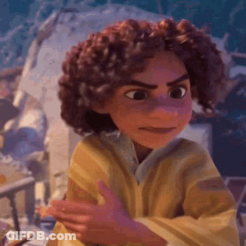 A Cartoon Character With Curly Hair And A Yellow Shirt Is Making A Funny Face . GIF