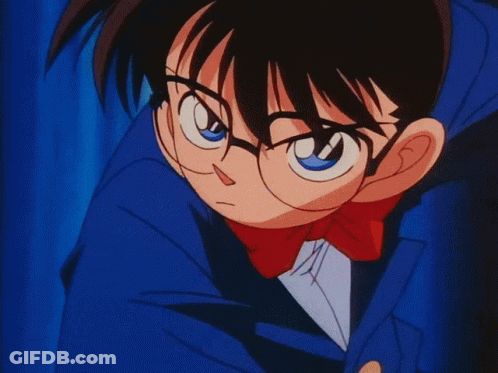 A Cartoon Character With Glasses And A Blue Jacket Is Standing In Front Of A Blue Curtain GIF
