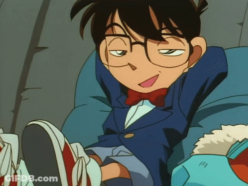 A Cartoon Character With Glasses And A Bow Tie Is Sitting On A Chair GIF
