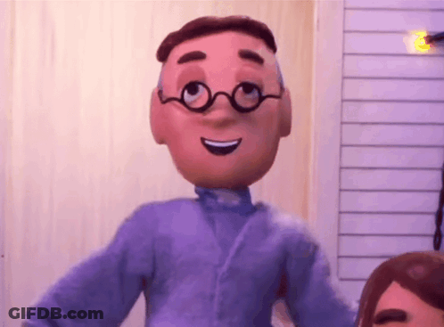 A Cartoon Character With Glasses And A Purple Shirt Is Smiling And Looking At The Camera . GIF